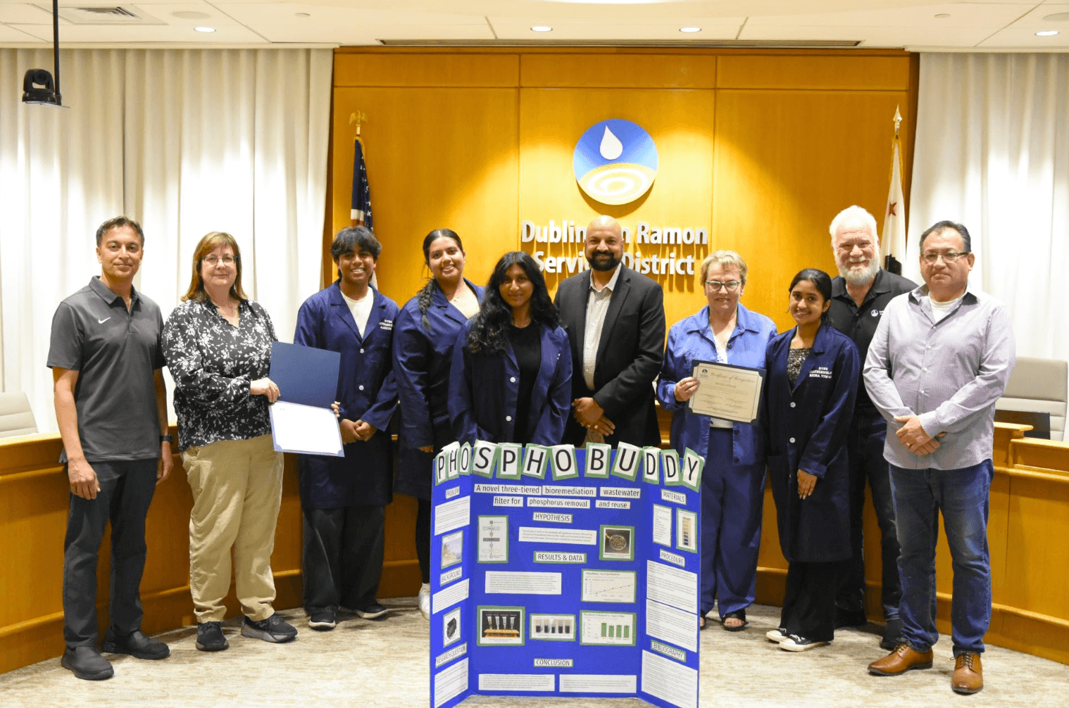 PhosphoBuddy team receiving recognition at the Dublin San Ramon Services District, standing beside their science fair board