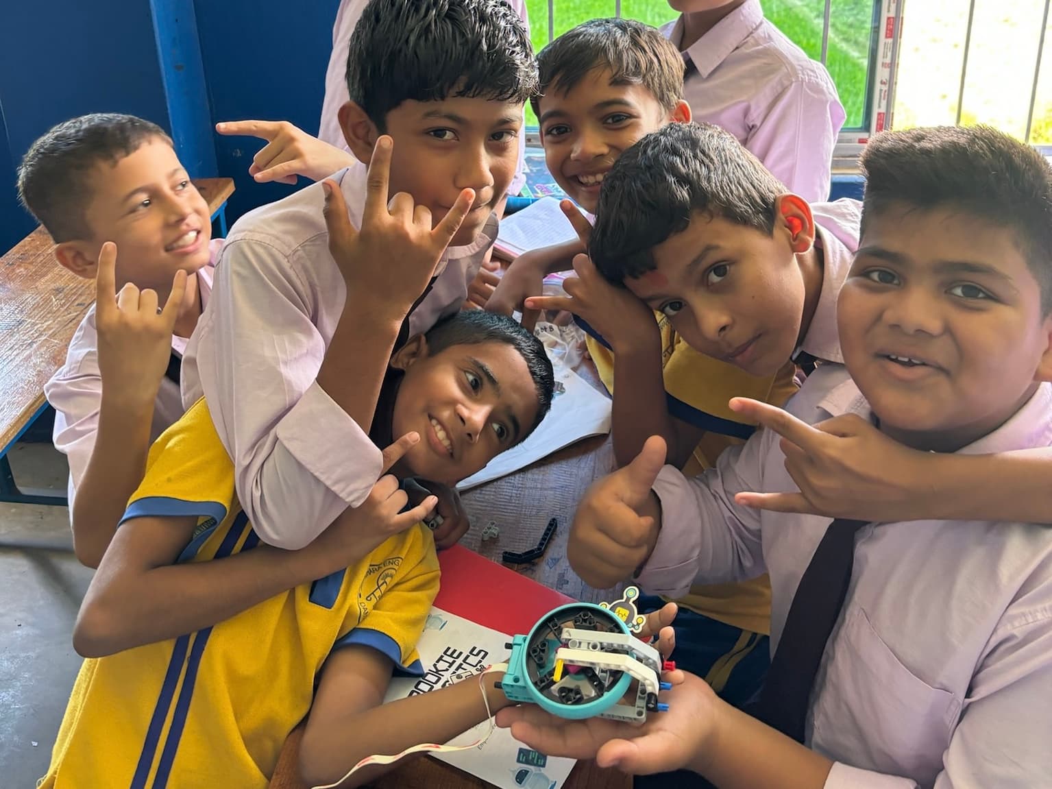 Students proudly showing off the robot they built together